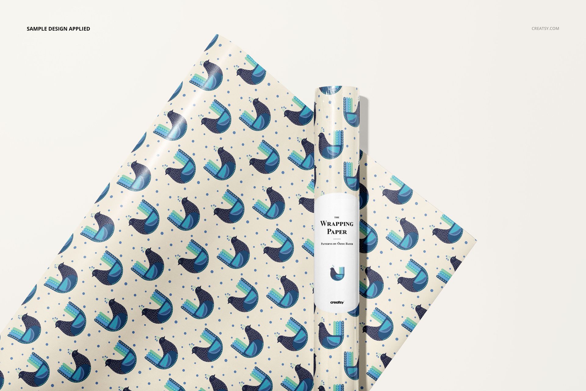 Gift wrapping paper mockup featuring a rolled sheet and flat sheet with blue and black abstract pattern on white.