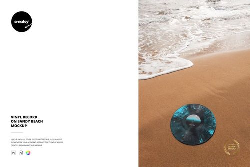 Top view of a vinyl record with a blue-black swirl design placed on wet sand by the shoreline, mockup setting.