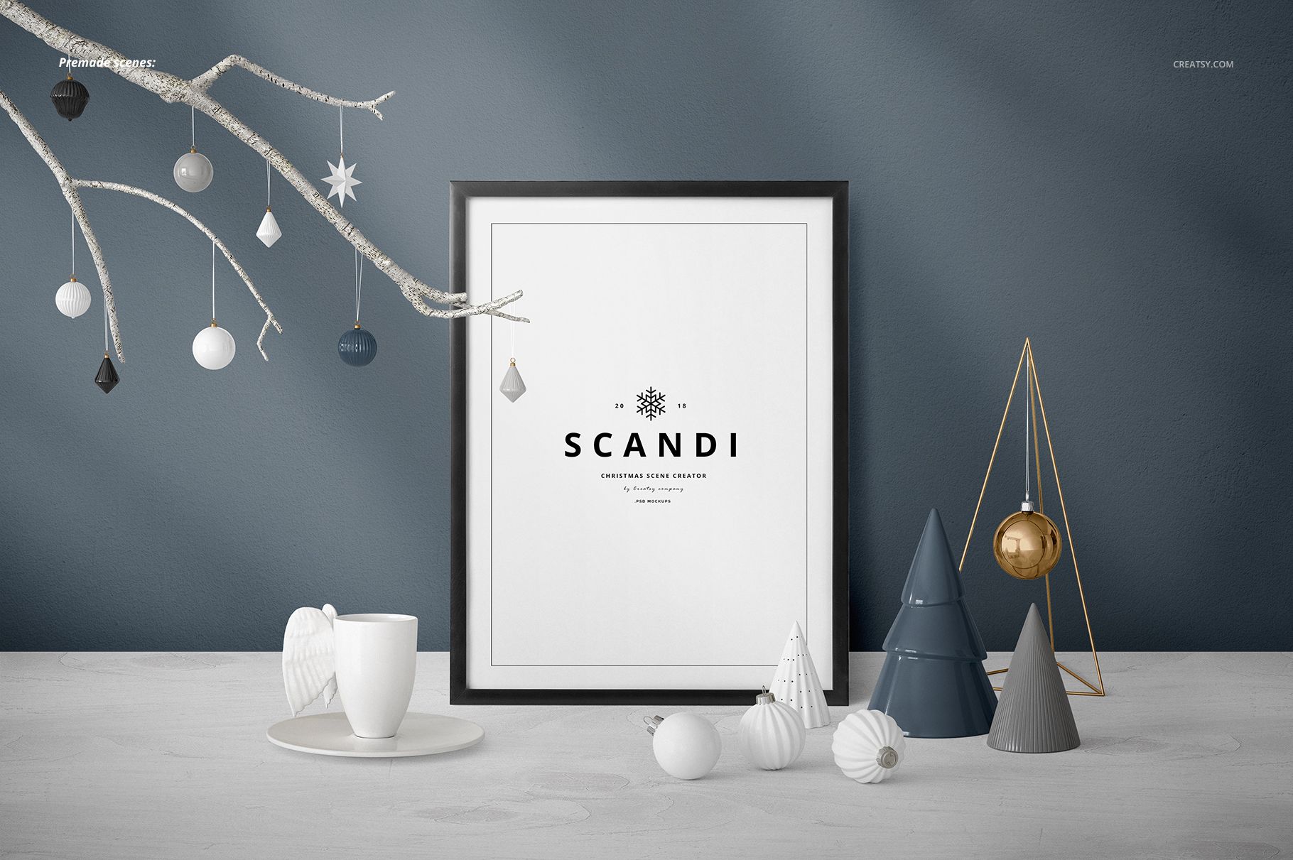Christmas scene mockup featuring a framed print, white cup, baubles, and minimalist tree decorations on a gray background.