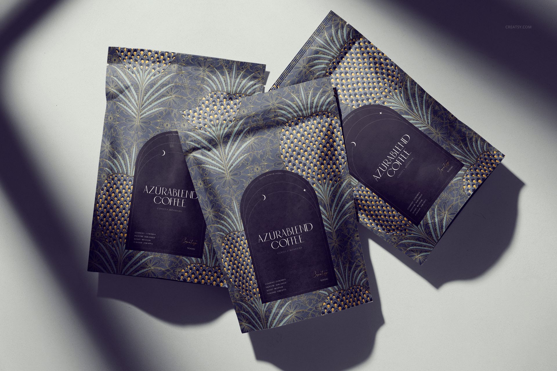 PSD mockup of coffee packaging with elegant leaf and geometric motifs in dark tones, viewed from above with shadows.
