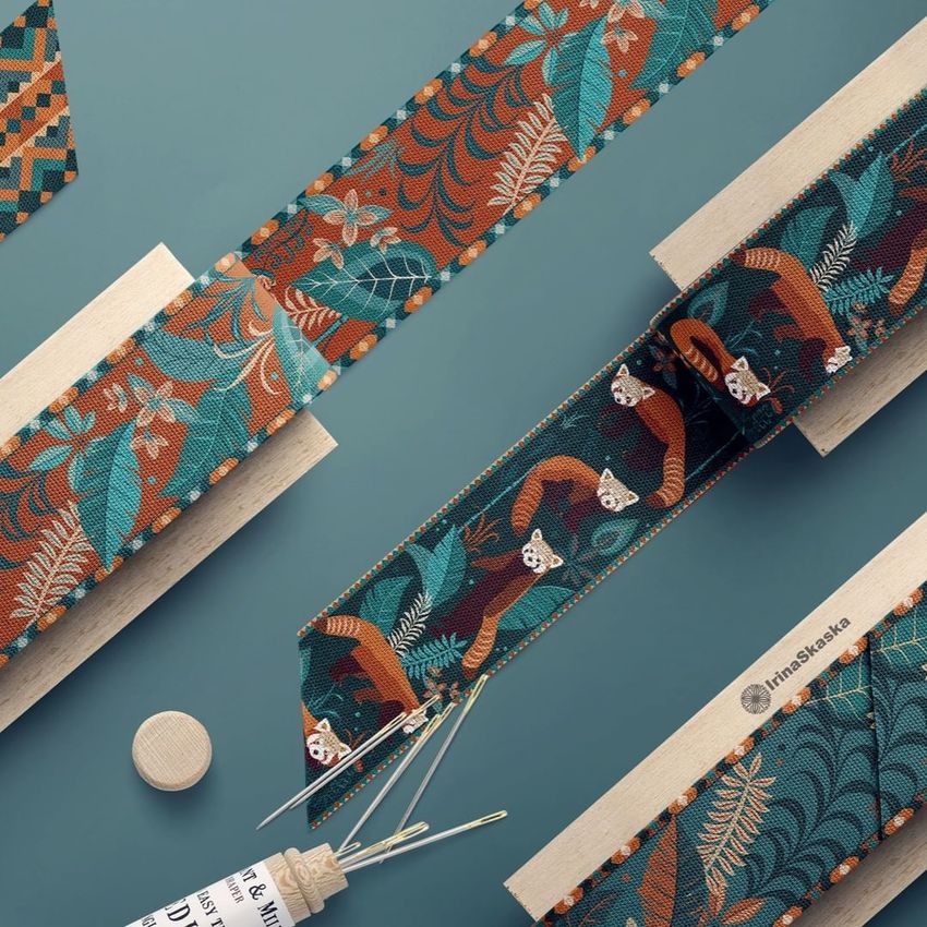 Cotton ribbon mockup featuring colorful patterned ribbons with red panda and leaf designs, displayed on wooden paddles against a blue background.