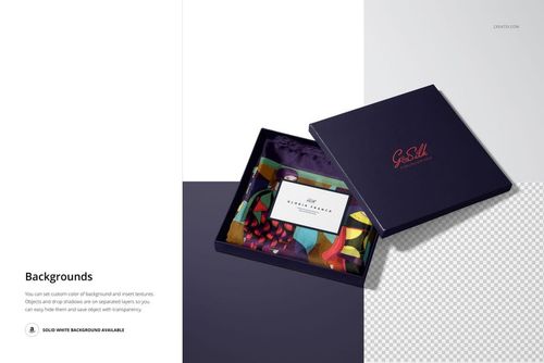 Top view of a mockup set featuring a folded multicolored silk scarf inside a navy blue box with a matching lid nearby.