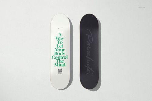 Skateboard deck PSD mockup set showing two boards side by side, featuring contrasting white and black designs.