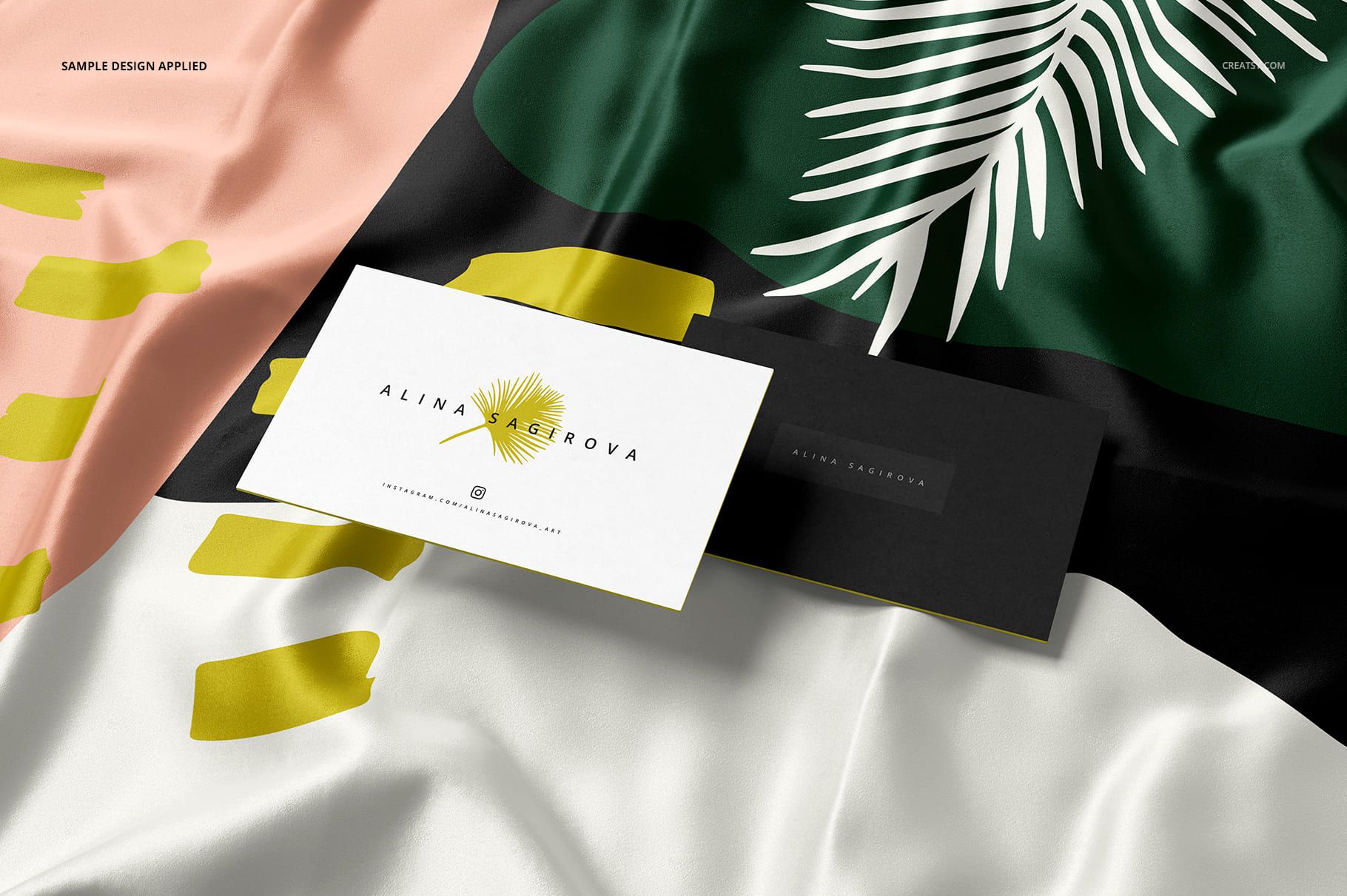 Silk fabric mockup with a laser cut finish featuring abstract patterns in green, black, pink, and white, shown in a close-up view.