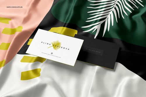 Silk fabric mockup with a laser cut finish featuring abstract patterns in green, black, pink, and white, shown in a close-up view.