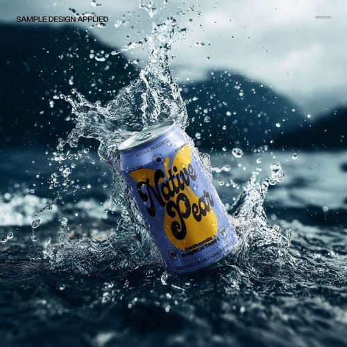 PSD mockup of a beverage can featuring vibrant artwork, surrounded by water splash and natural scenery.