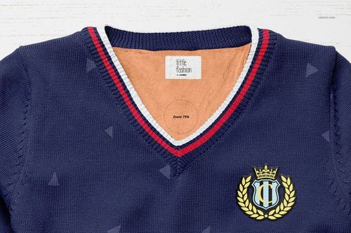 Front view of a boys sweater mockup in navy blue with a V-neck, red and white striped trim, and crest emblem on chest.