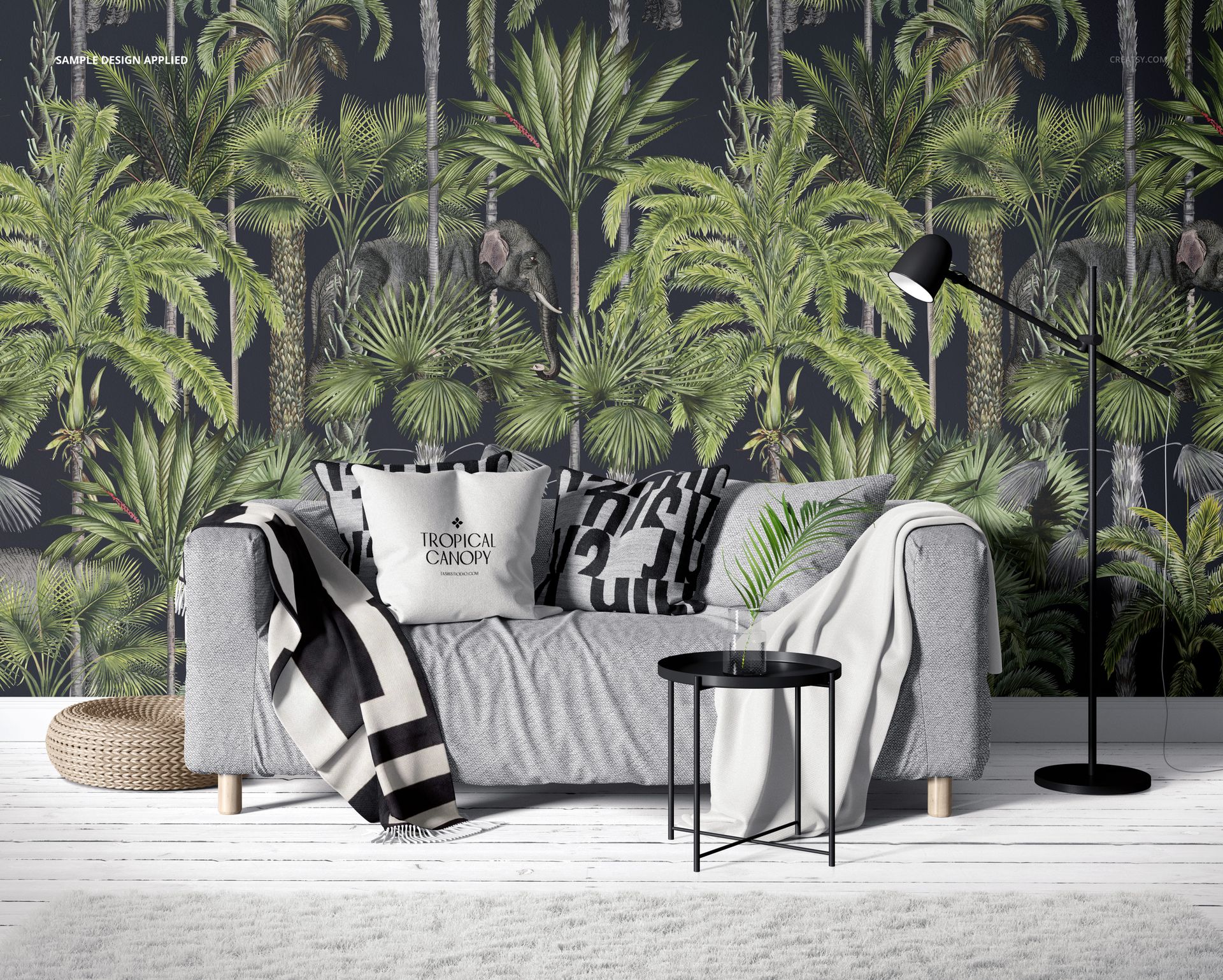 Front view of a modern living room with a gray sofa, patterned pillows, and tropical palm wallpaper mockup.