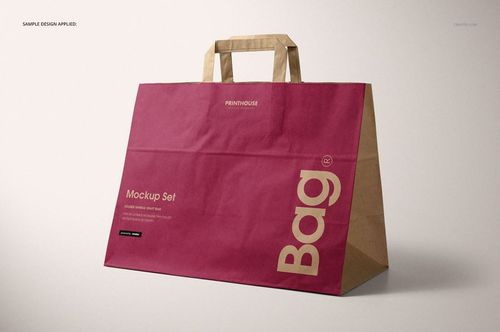Large kraft paper bag mockup with folded handles, featuring magenta panel and bold lettering, displayed at an angle.