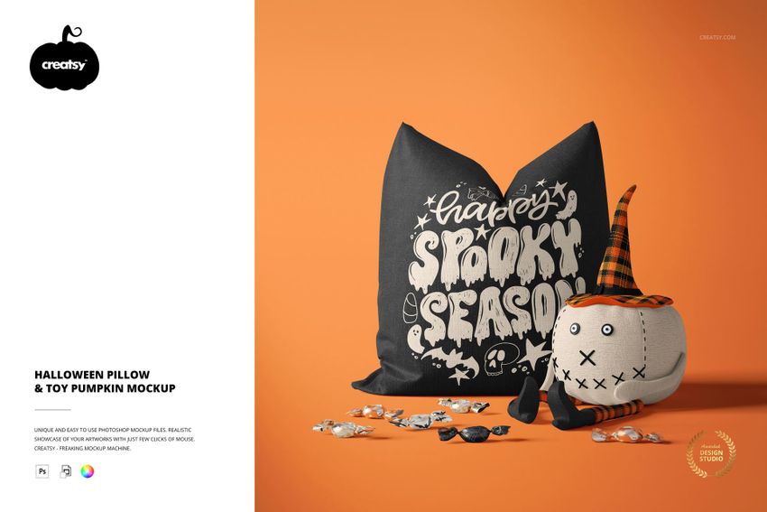 PSD mockup showing a decorative pillow with Halloween graphics and a soft pumpkin toy surrounded by candy on a vibrant orange surface.