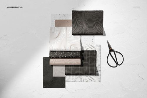 Fabric mockup set featuring rectangular textile samples with grid and wave designs, scissors placed nearby.