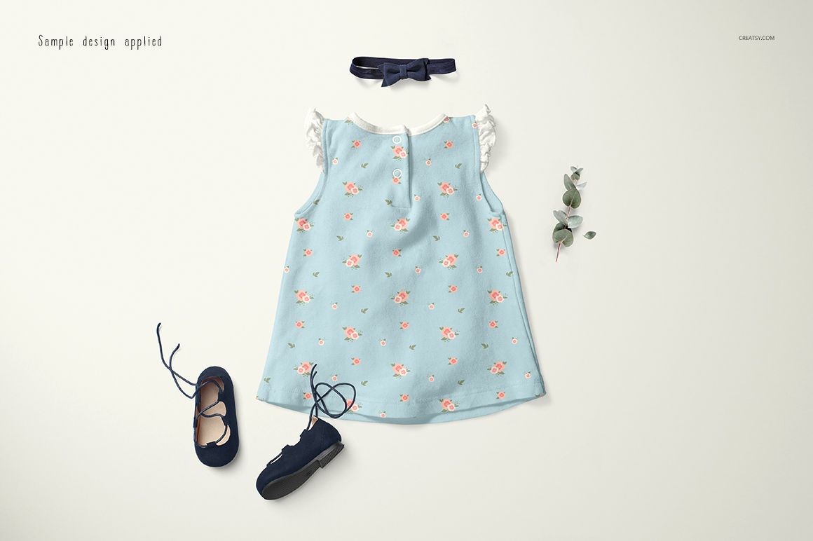 Baby dress mockup set showing a sleeveless blue dress with pink flowers, navy shoes, and a matching headband.