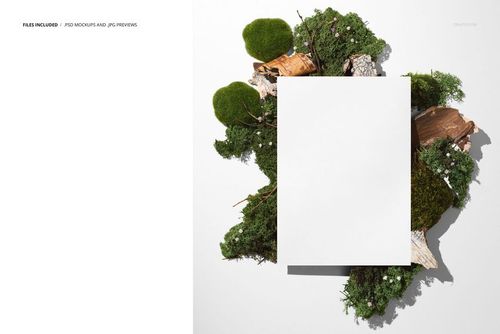 Front view of a blank poster mockup placed on a white surface, surrounded by green moss, bark, and small flowers.