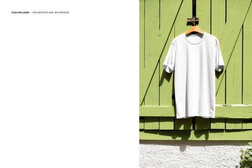 PSD mockup of a white short-sleeve t-shirt hanging on green window shutters with sunlight and shadow detail.