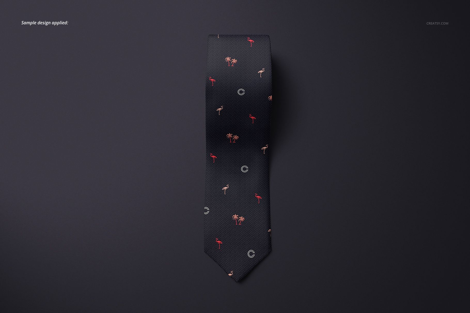 Black tie mockup shown flat against a dark surface, decorated with scattered tiny red and tan design elements.