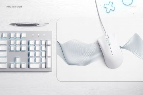 Top view of a rectangular gaming mouse pad mockup with a white and light blue wave pattern, next to a keyboard and mouse.
