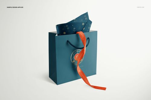 Front view of a blue jewelry box bag with circular logo, orange ribbon, and dark blue tissue paper mockup.