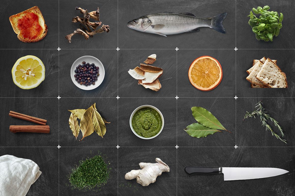Slate plate mockup with various food items and herbs arranged in a grid, viewed from above on a dark background.
