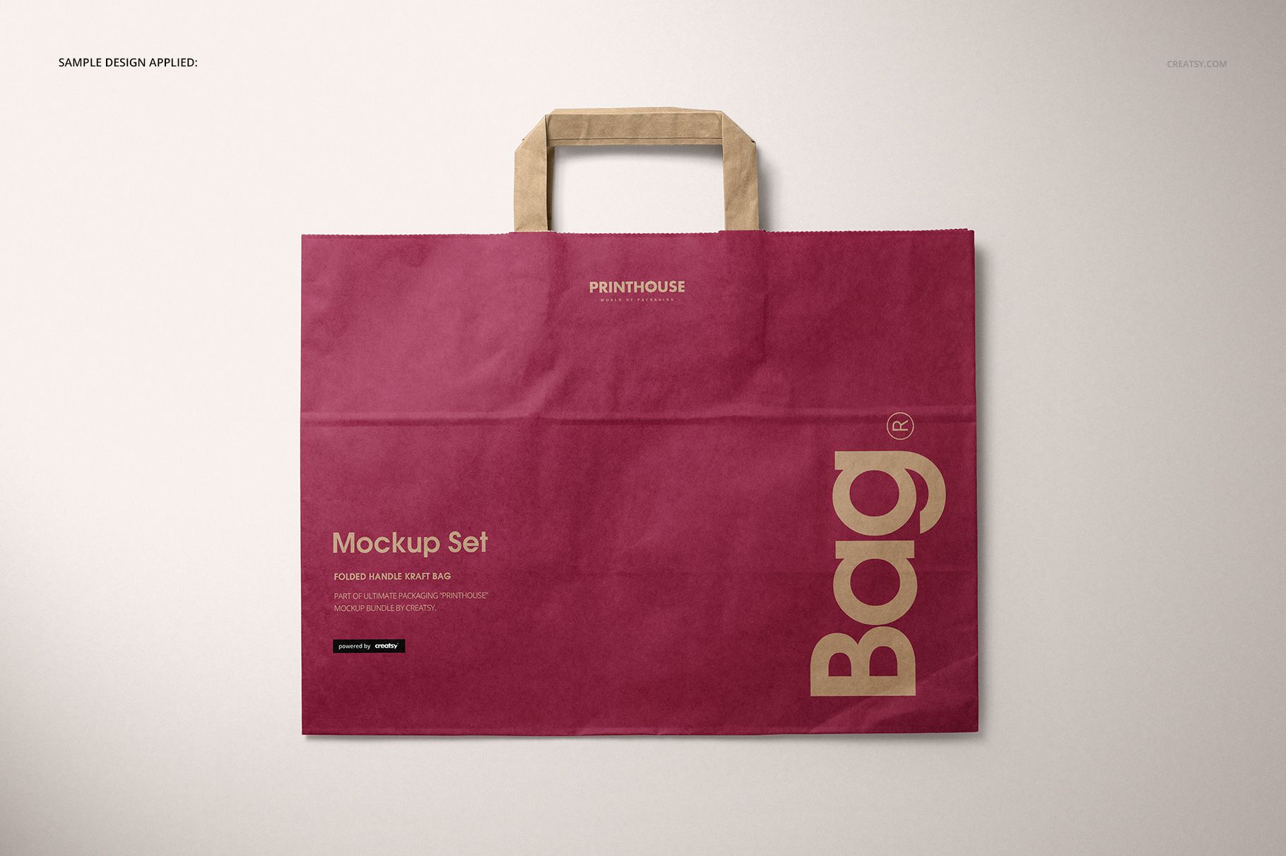 Folded handle kraft paper bag mockup featuring a burgundy design and beige paper handles, displayed flat.