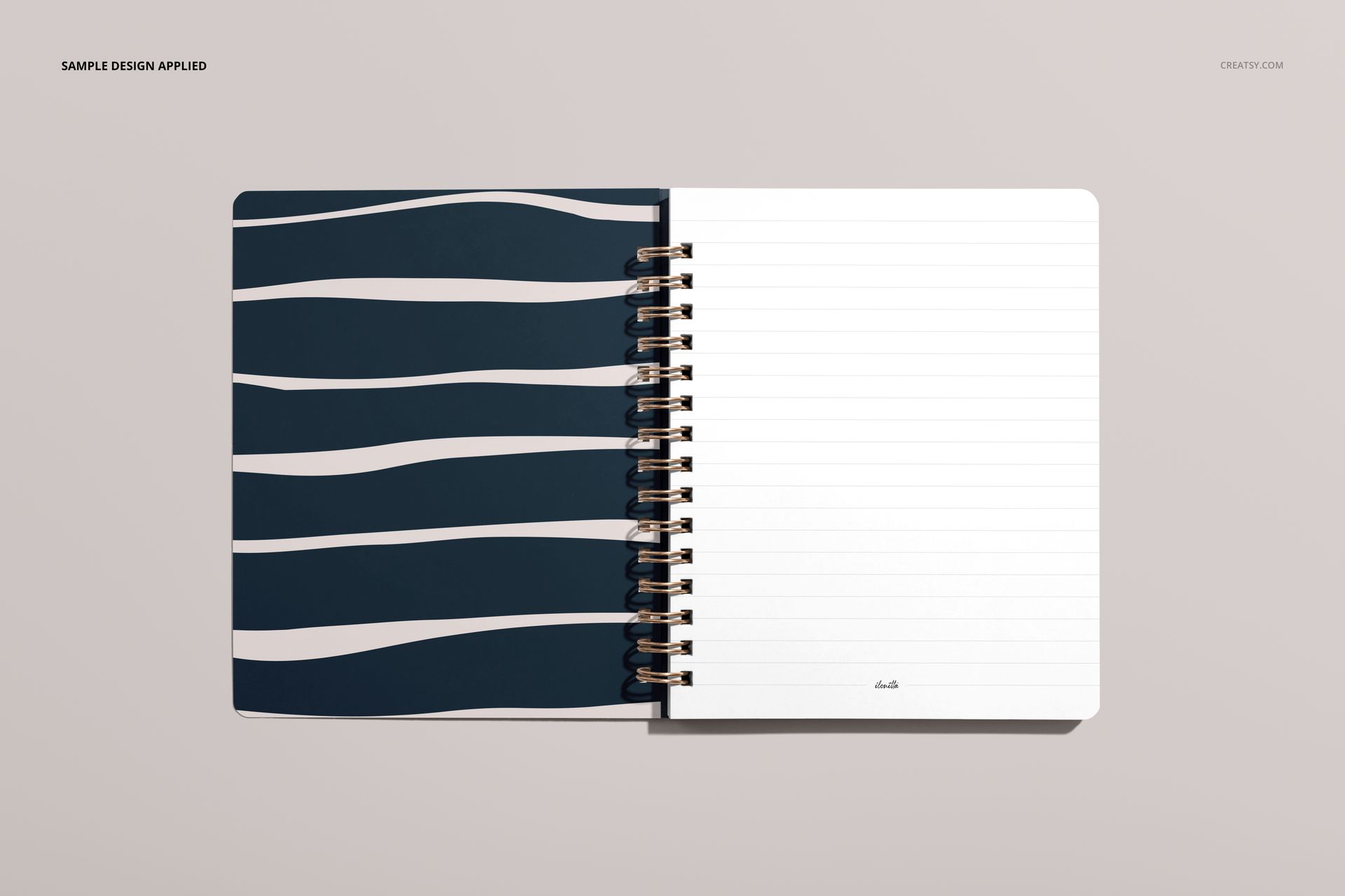 Top view of a small spiral notebook mockup, left side has abstract navy and white stripes, right side lined pages.