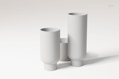 Front view of three stoneware vases in matte white finish, arranged on a light surface with soft shadows.