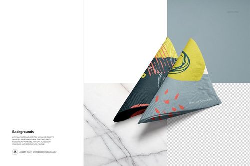 Mockup of two triangular paper napkins featuring modern patterns, placed on a marble surface with a transparent section.