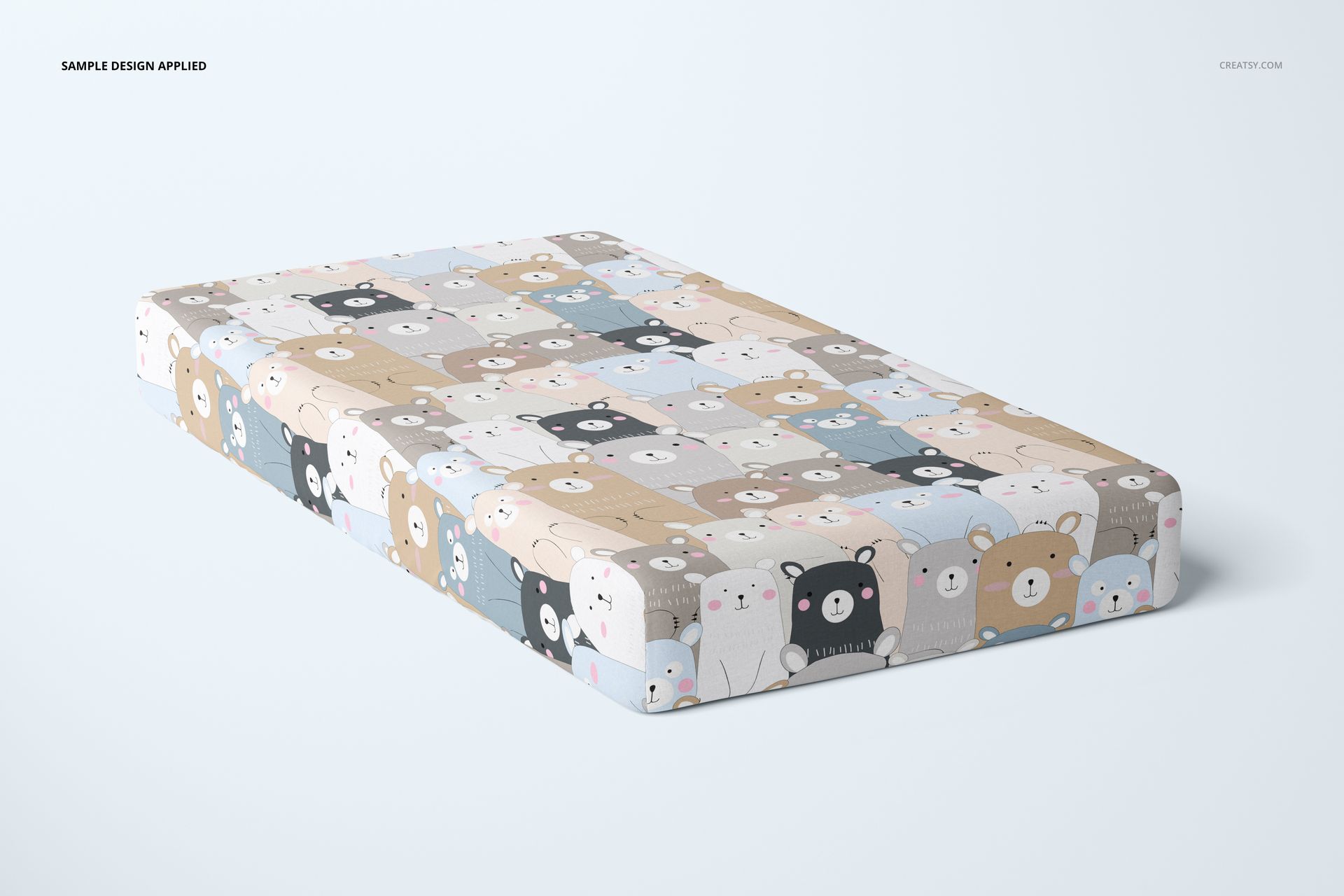 Crib sheet mockup featuring a grid of cartoon animal faces in soft beige, blue, and gray tones, displayed at an angle.