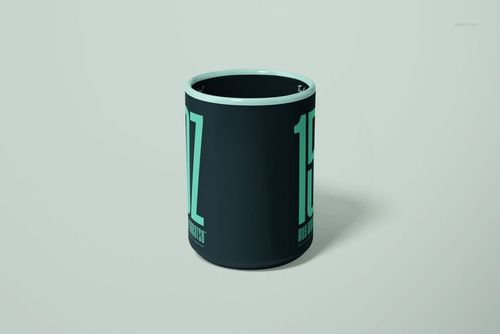 15oz mug mockup featuring bold light teal lettering on a dark surface, displayed with a simple neutral backdrop.