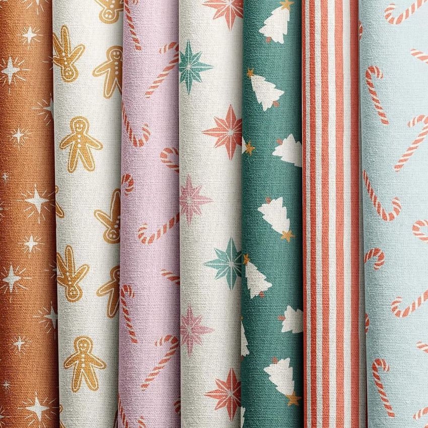 Fabric stack mockup featuring seven folded fabric pieces with festive patterns like stars, gingerbread, candy canes, and trees.
