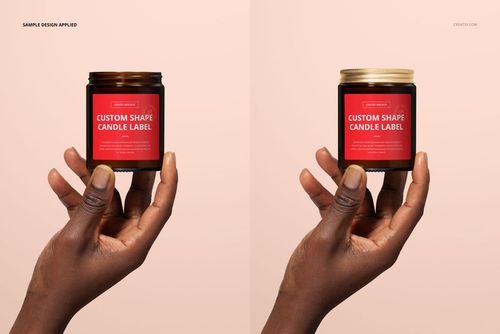 Amber jar candle mockup featuring cotton wick, each held by a hand with a red label, set on a neutral backdrop.