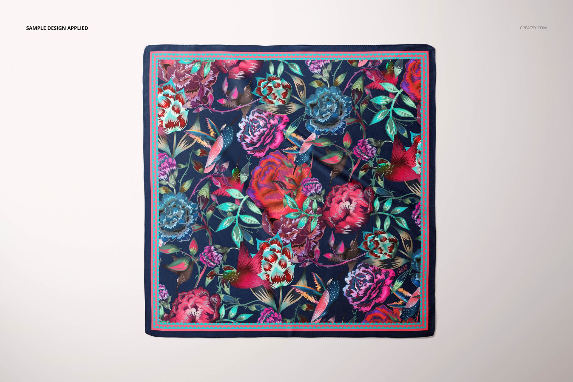 Colorful square silk scarf mockup with a botanical design in shades of pink, red, and green on a dark background.