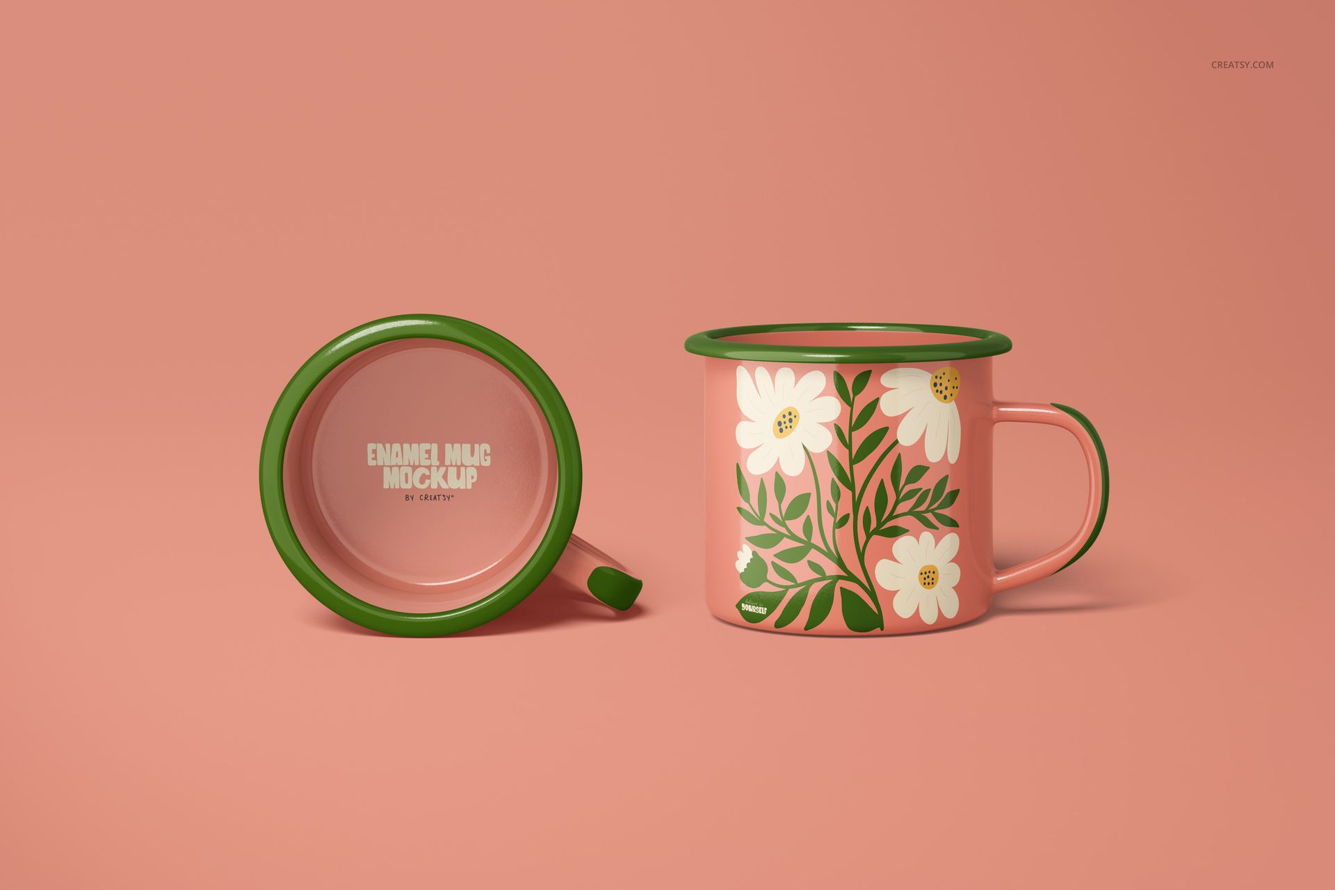 Enamel mug mockup featuring a floral pattern with white flowers and green leaves, shown from side and top view on a pink background.