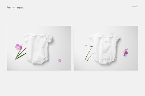 PSD mockup showing a white baby romper in two angles, surrounded by a purple orchid flower and scattered petals.