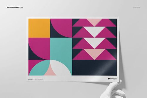 Front view of a Hahnemühle Fine Art Pearl print mockup with bold geometric patterns in vibrant colors, held by a gloved hand.
