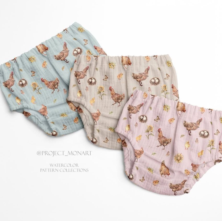 Three baby muslin pants with watercolor chicken and floral patterns are arranged on a white background, each in a different pastel color.