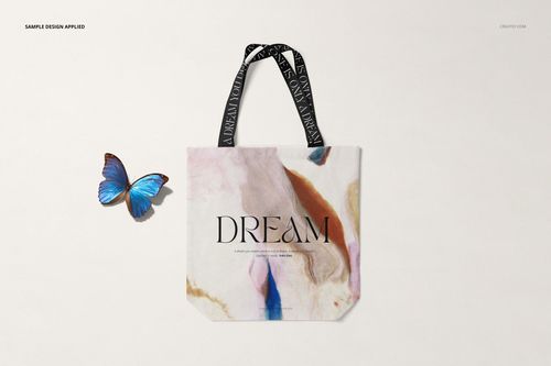 Front view of a shopper canvas bag mockup with abstract pastel pattern and black handles, placed on a light background.
