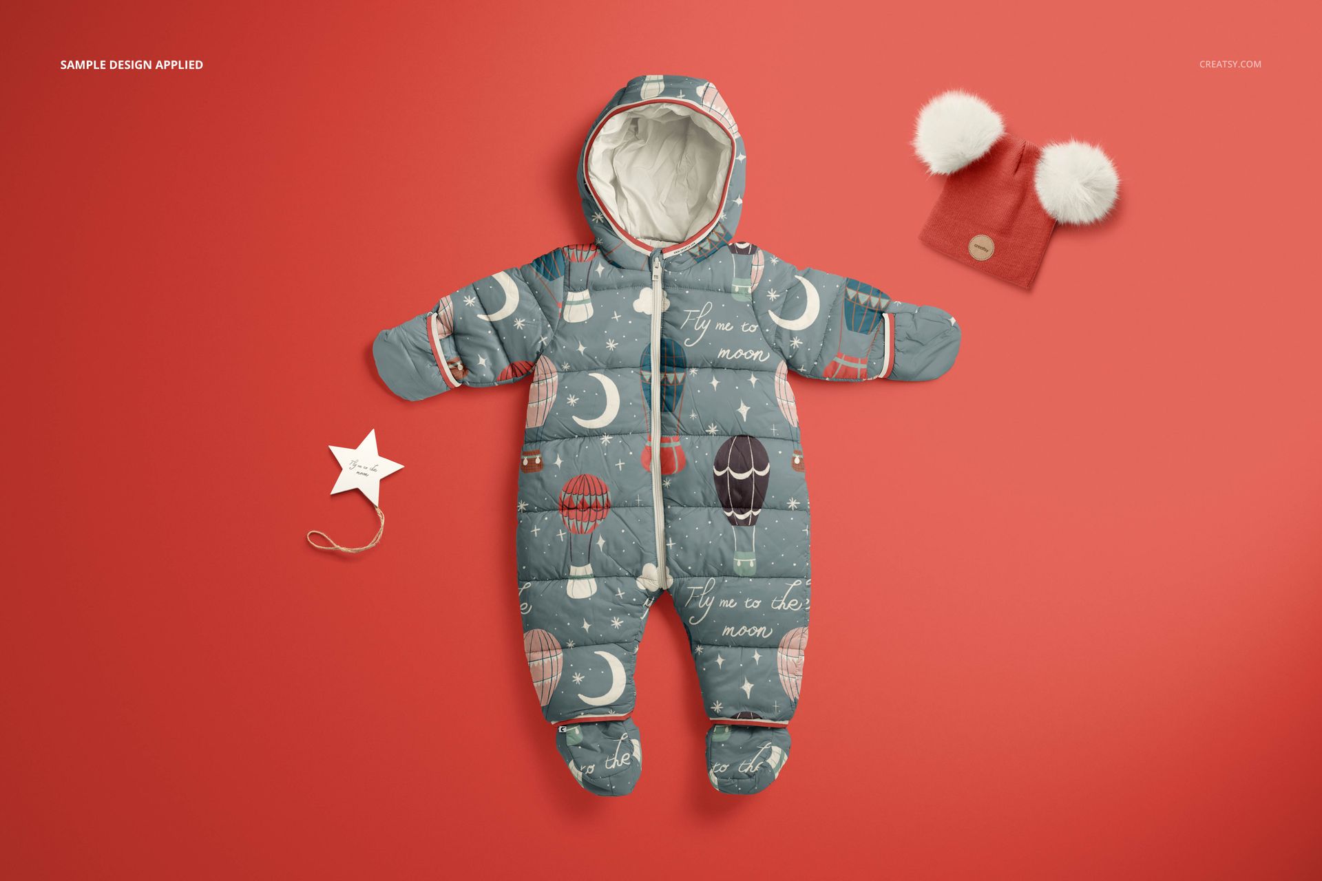 Front view of a baby snowsuit mockup with whimsical moon and balloon pattern, displayed on a red background.