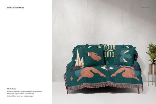 Mockup of a fringed throw blanket with teal and pastel designs displayed on a couch in a minimalist room.