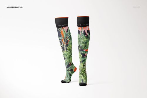 Pair of knee high socks mockup featuring colorful jungle foliage and animal illustrations, displayed upright on white.