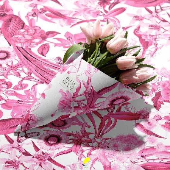 Flower packaging mockup featuring a bouquet of pale pink tulips wrapped in paper with a pink floral pattern on a matching background.