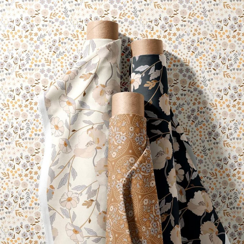 Fabric rolls mockup featuring three upright rolls with floral patterns in beige, gold, and navy, set against a matching floral backdrop.
