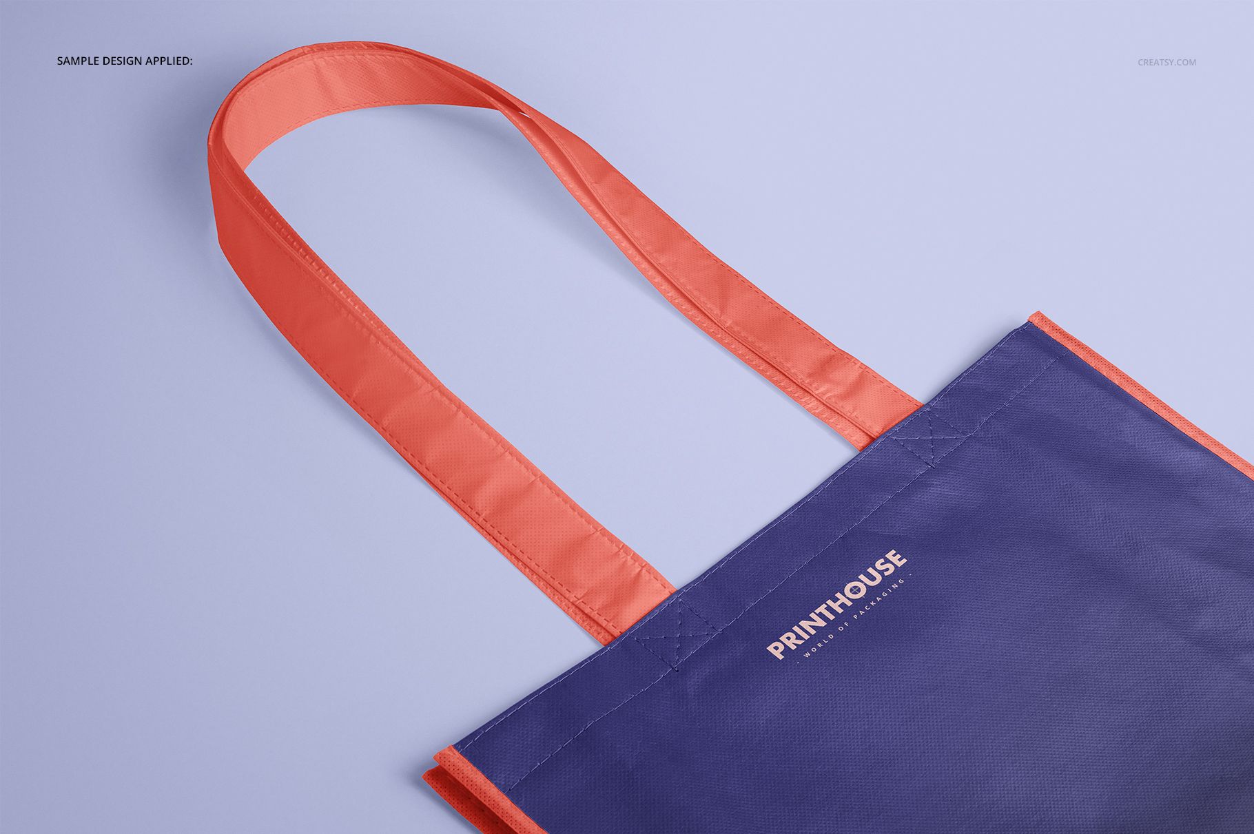 Front angled view of a laminated non-woven tote bag mockup with purple body and orange handles on a light background.