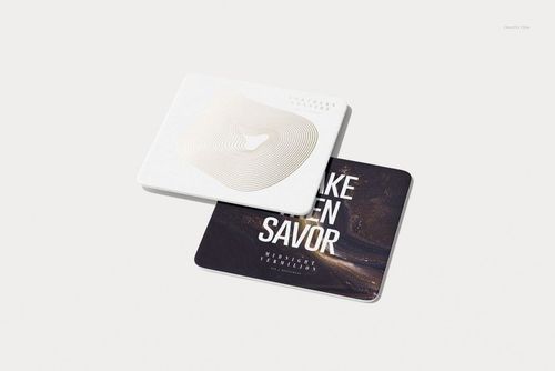 PSD mockup showing a pair of square drink coasters, one in white with foil stamping, the other with a printed design.