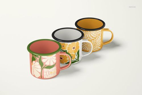 PSD mockup of enamel mugs with green, yellow, and pink floral prints, shown from a front angle in a studio setting.