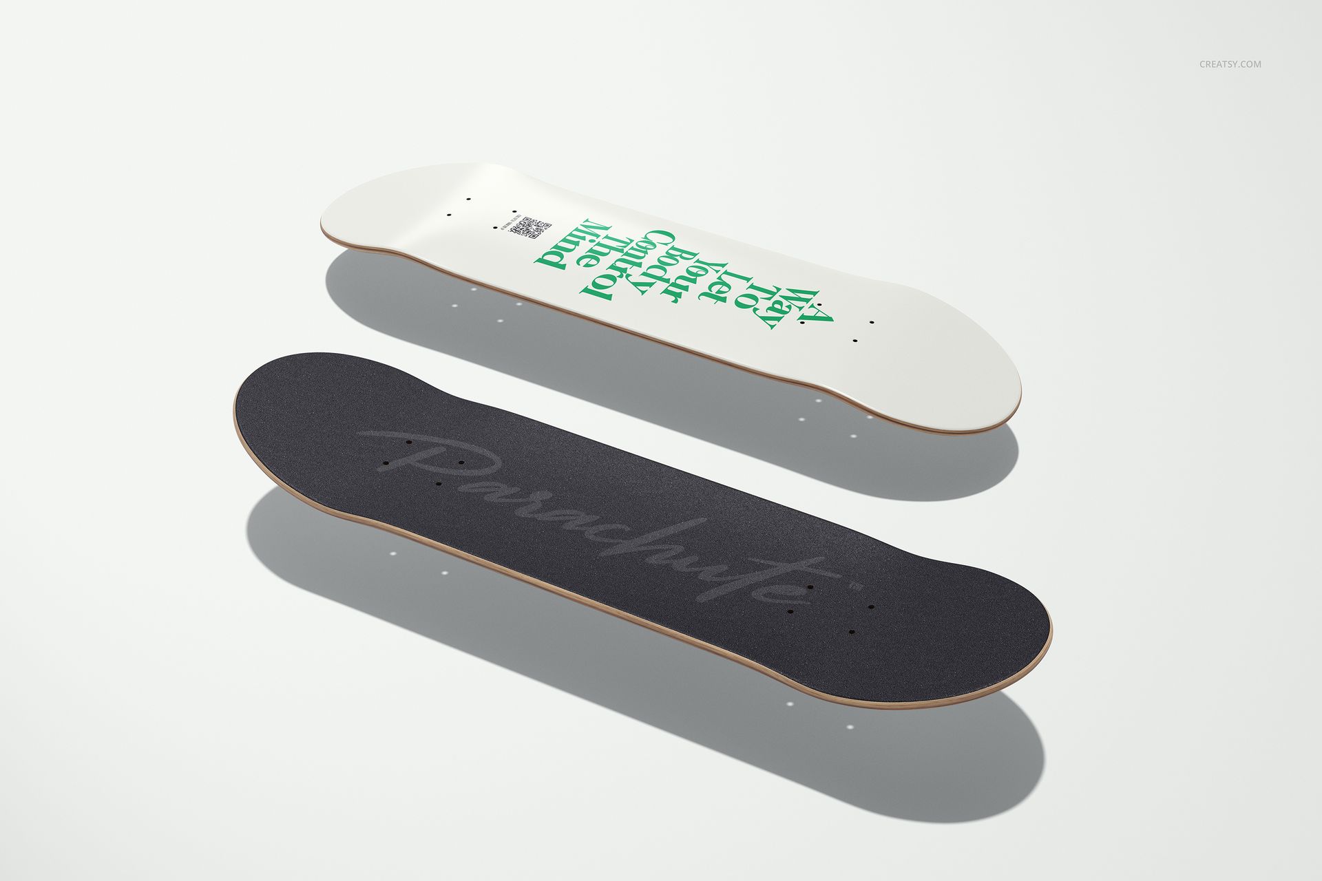 Skateboard deck mockup featuring one deck with a white underside and green lettering, and one with black grip tape.