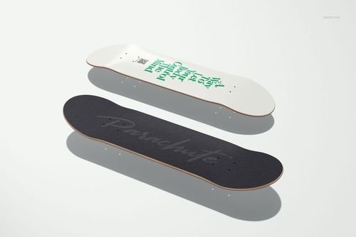 Skateboard deck mockup featuring one deck with a white underside and green lettering, and one with black grip tape.