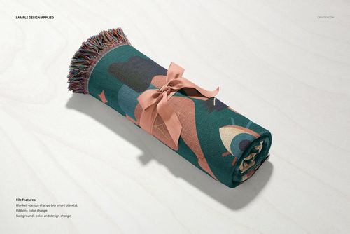 Jacquard fringed throw blanket mockup rolled up, featuring a bold abstract pattern and pink ribbon on a light surface.