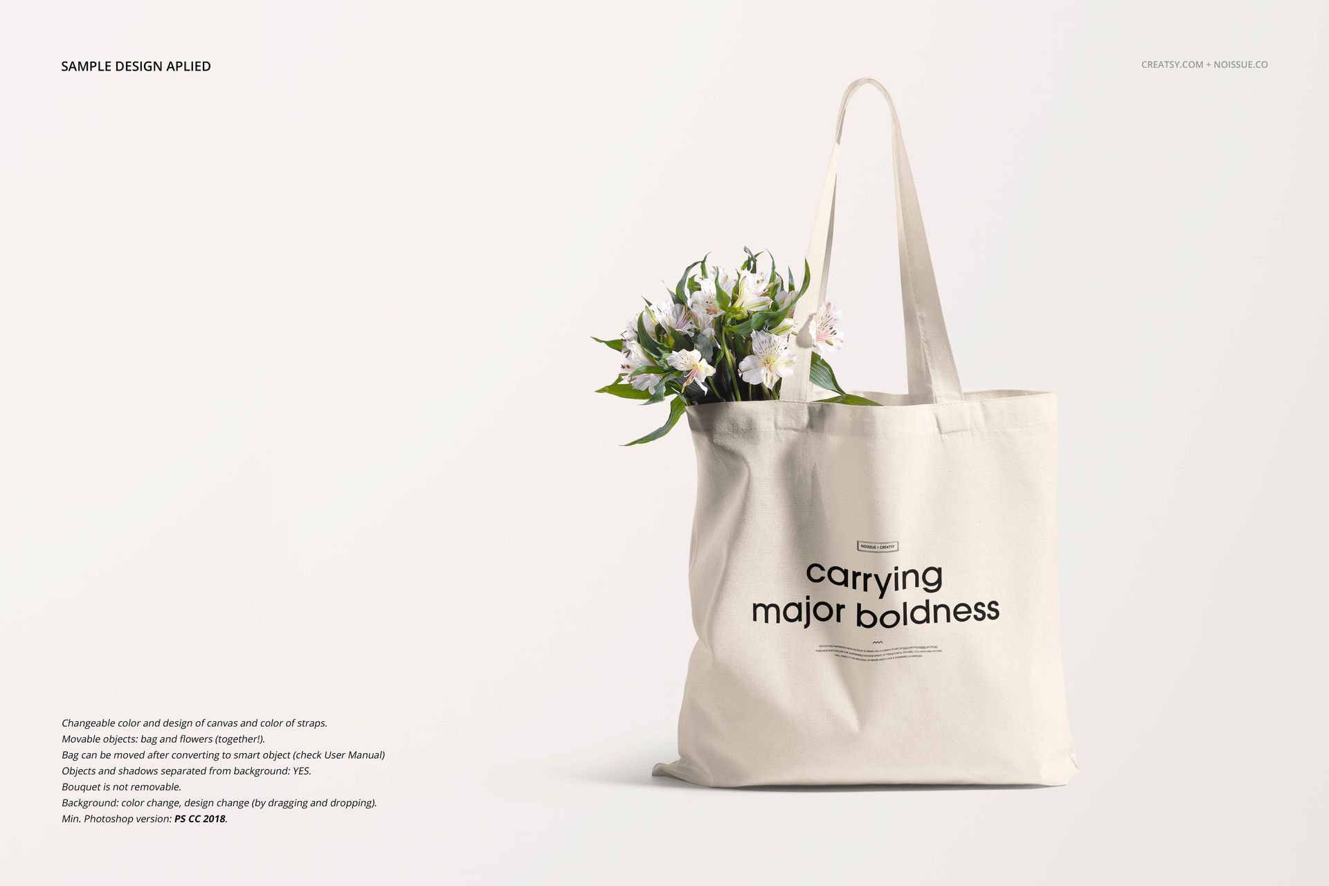 Front view of a cream-colored tote bag mockup with black text and white flowers inside, set against a light background.