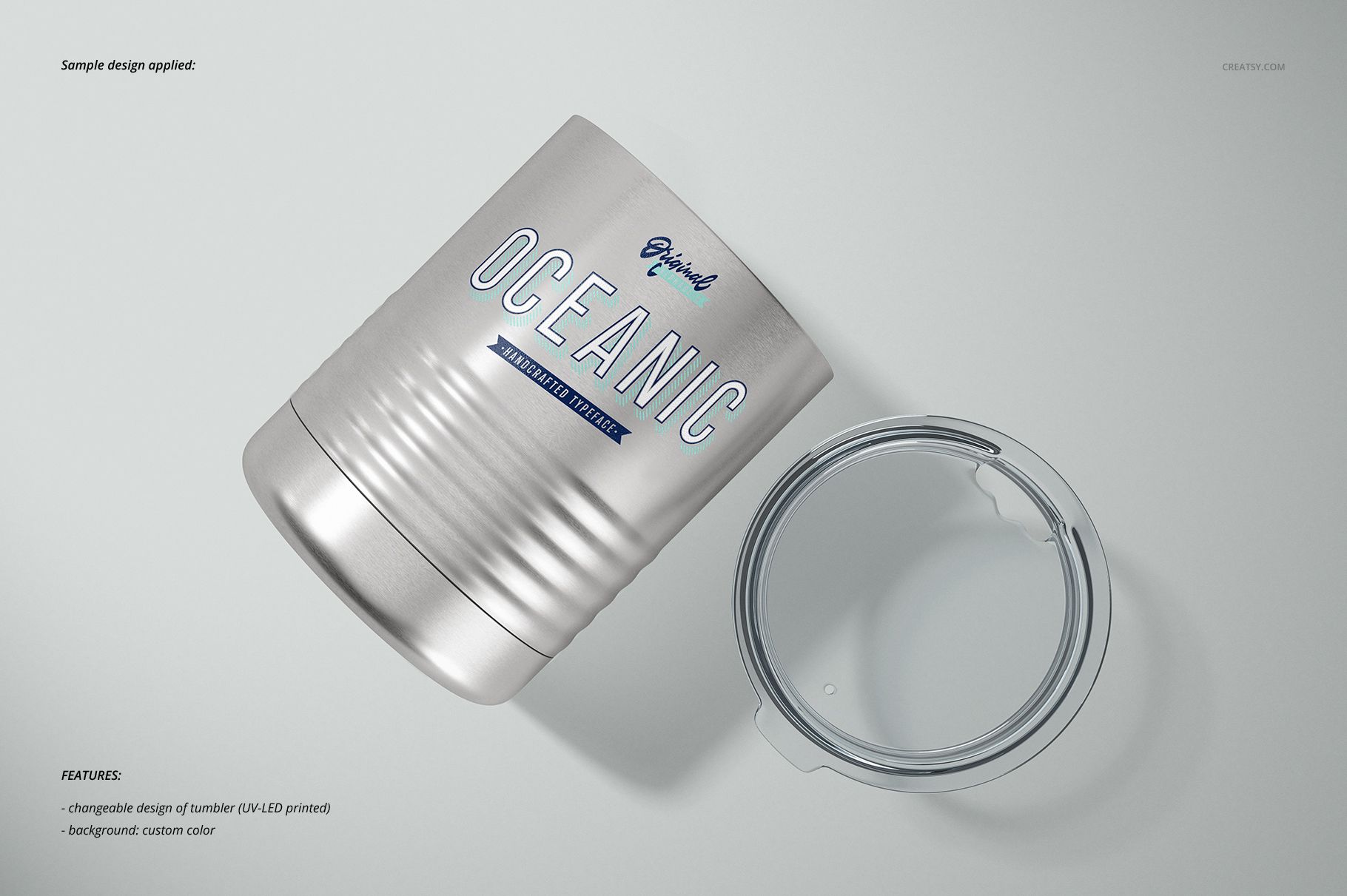 Front view of a vacuum insulated tumbler mockup in silver with engraved details and a detached transparent lid.