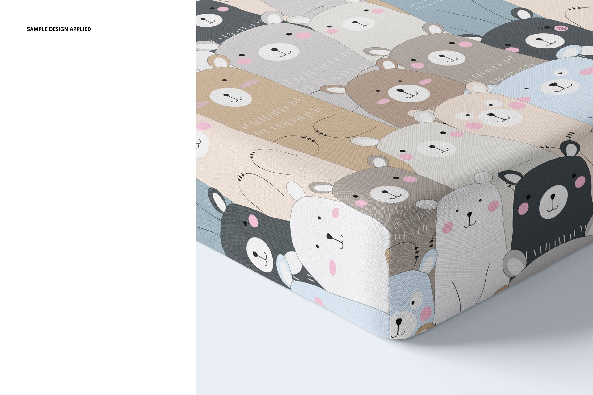 PSD mockup of a crib sheet featuring cute cartoon bear faces in soft beige, gray, and blue tones, corner perspective.